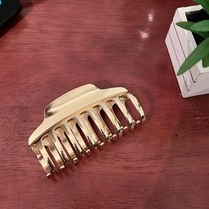 NEW gold metal claw clip from Urban outfitters. Holds hair securely.